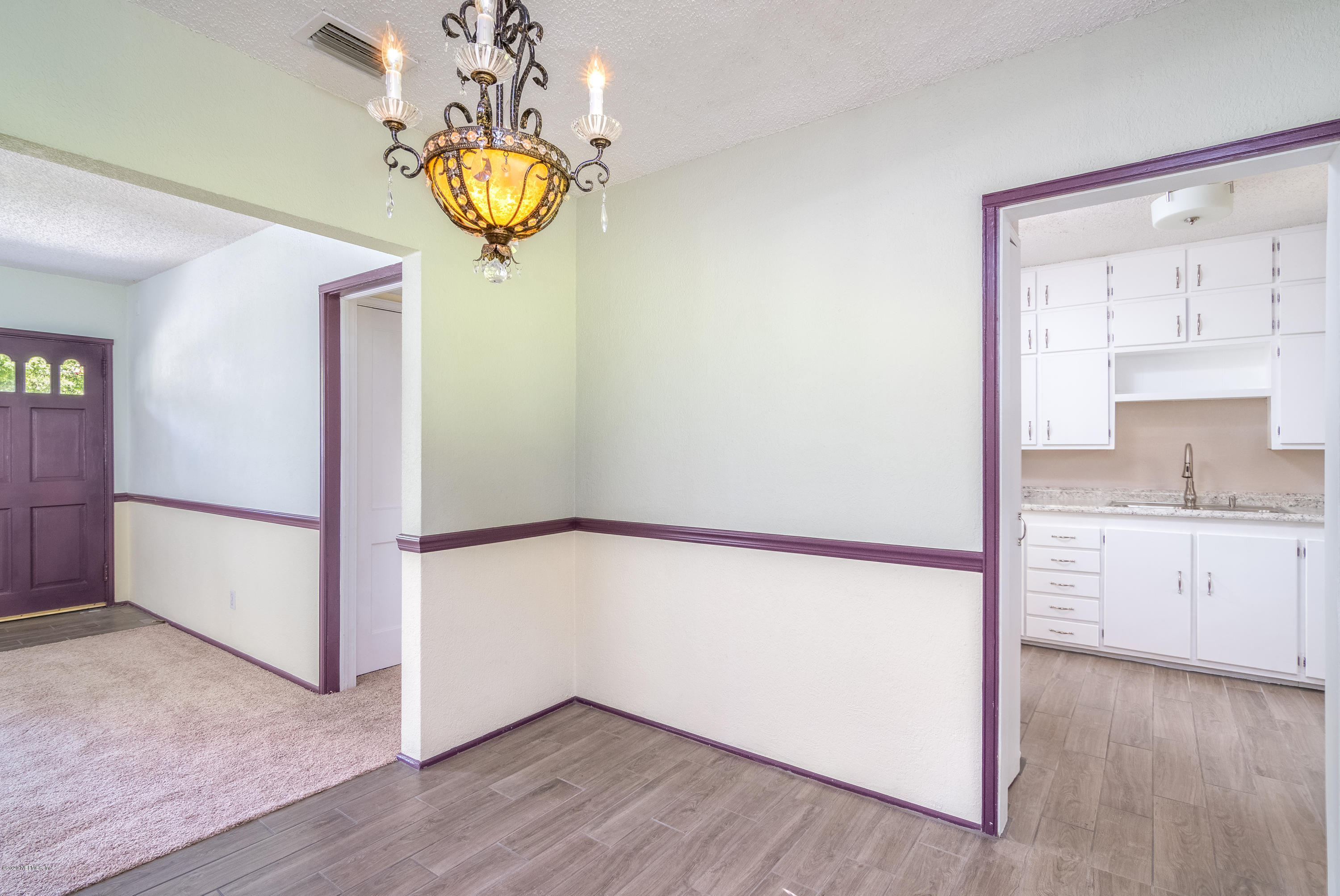 1790 Mayfair Road Jacksonville, FL 32207 - Photo 10 of 25 wooden floor in an empty room with a window