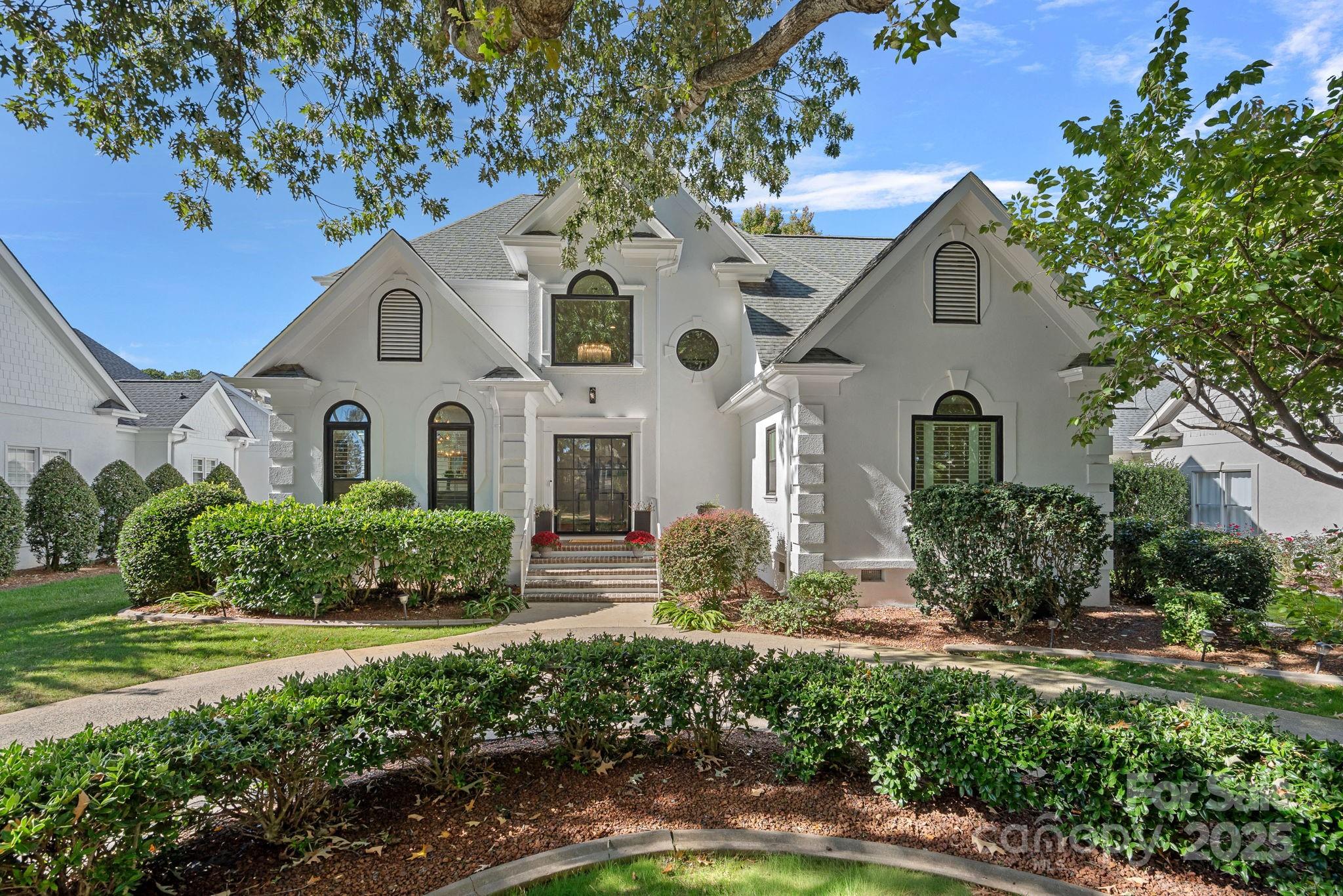 a front view of a house with garden
