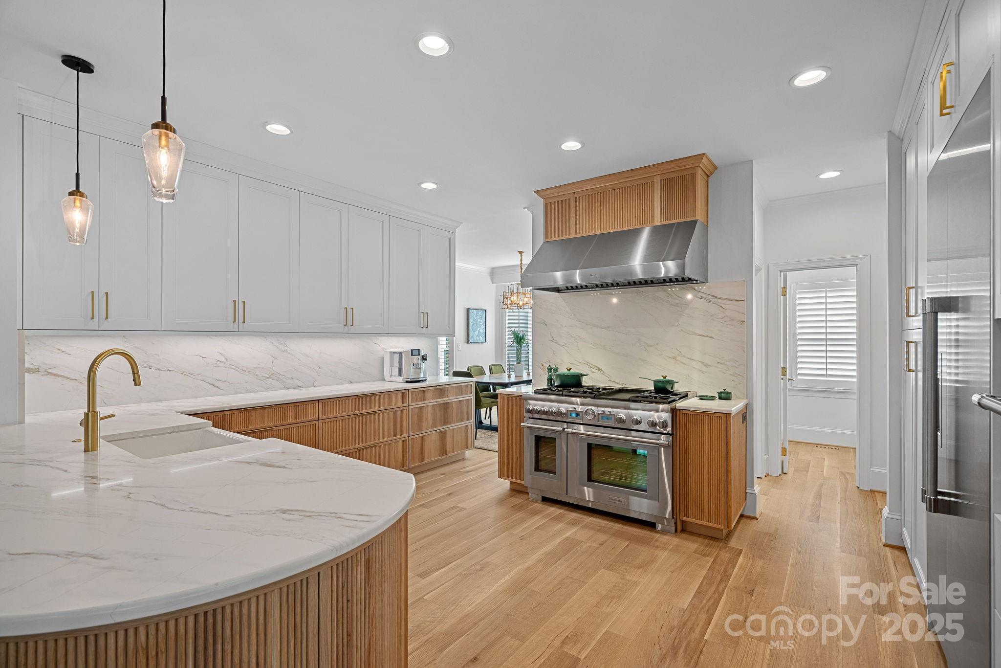 18613 John Connor Road Cornelius, NC 28031 - Photo 12 of 48 a kitchen with stainless steel appliances granite countertop a sink a stove and a refrigerator