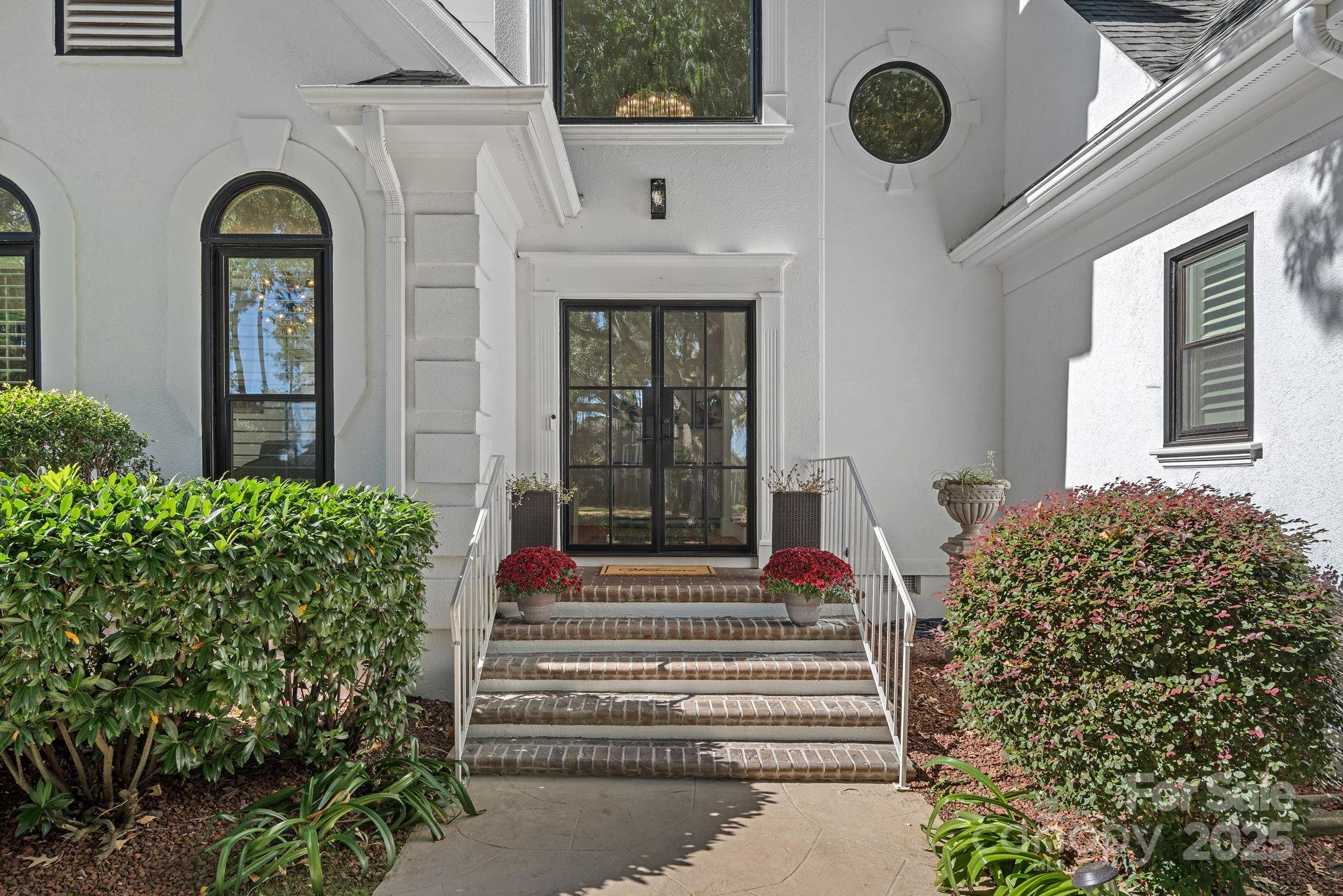 18613 John Connor Road Cornelius, NC 28031 - Photo 2 of 48 a front view of a house with a garden