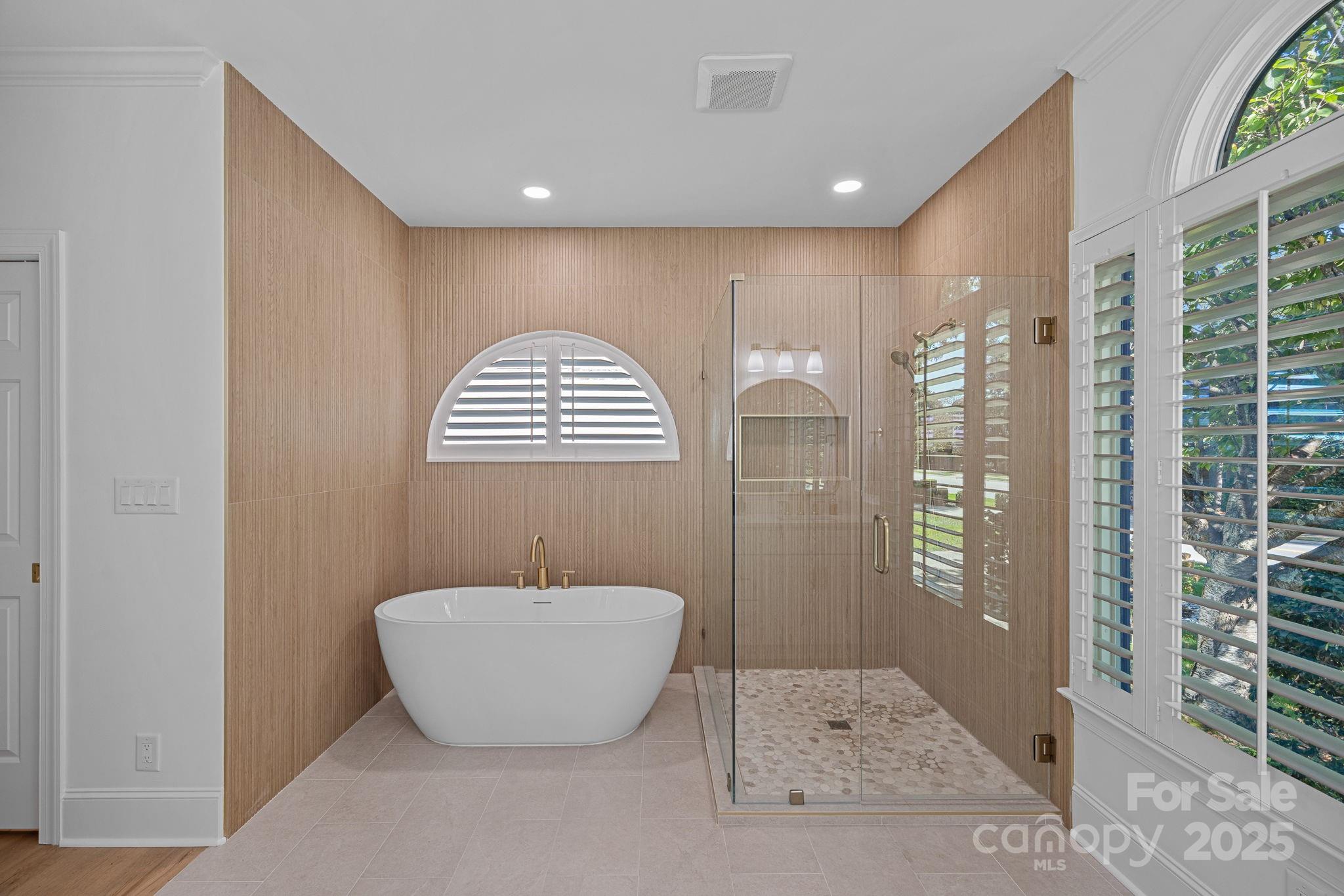 18613 John Connor Road Cornelius, NC 28031 - Photo 24 of 48 a bathroom with a bathtub and shower