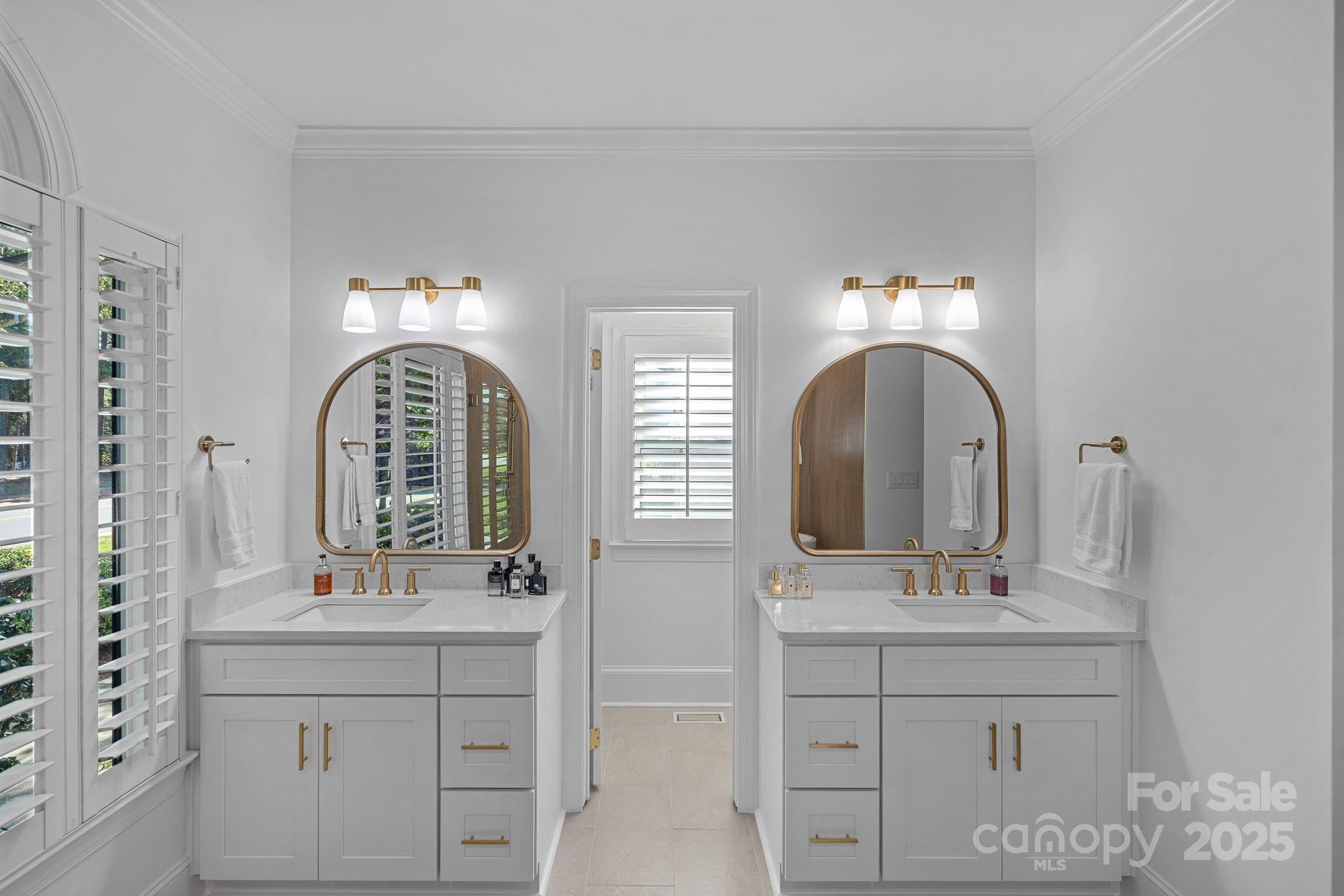 18613 John Connor Road Cornelius, NC 28031 - Photo 25 of 48 a bathroom with double vanity sinks and a mirror