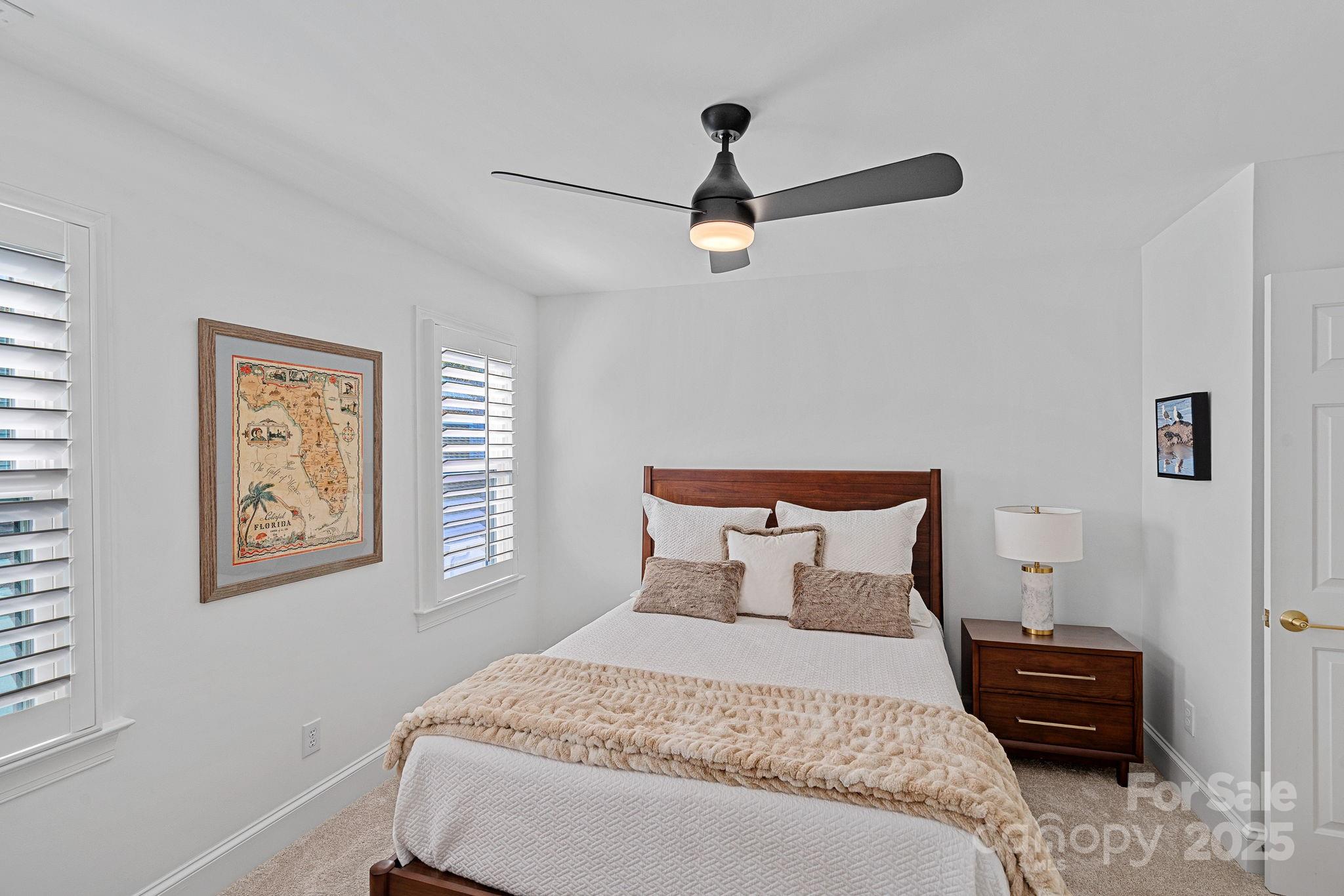 18613 John Connor Road Cornelius, NC 28031 - Photo 32 of 48 a bedroom with a bed and a painting on the wall