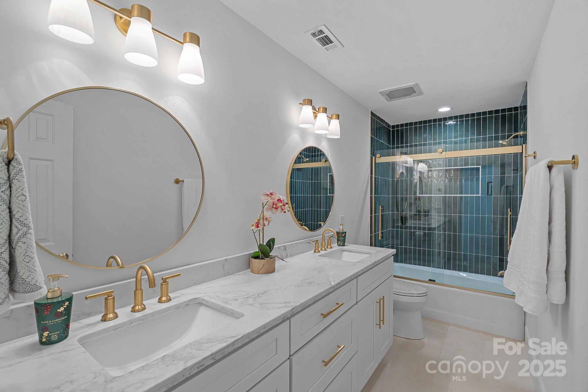 18613 John Connor Road Cornelius, NC 28031 - Photo 33 of 48 a bathroom with a double vanity sink and a mirror