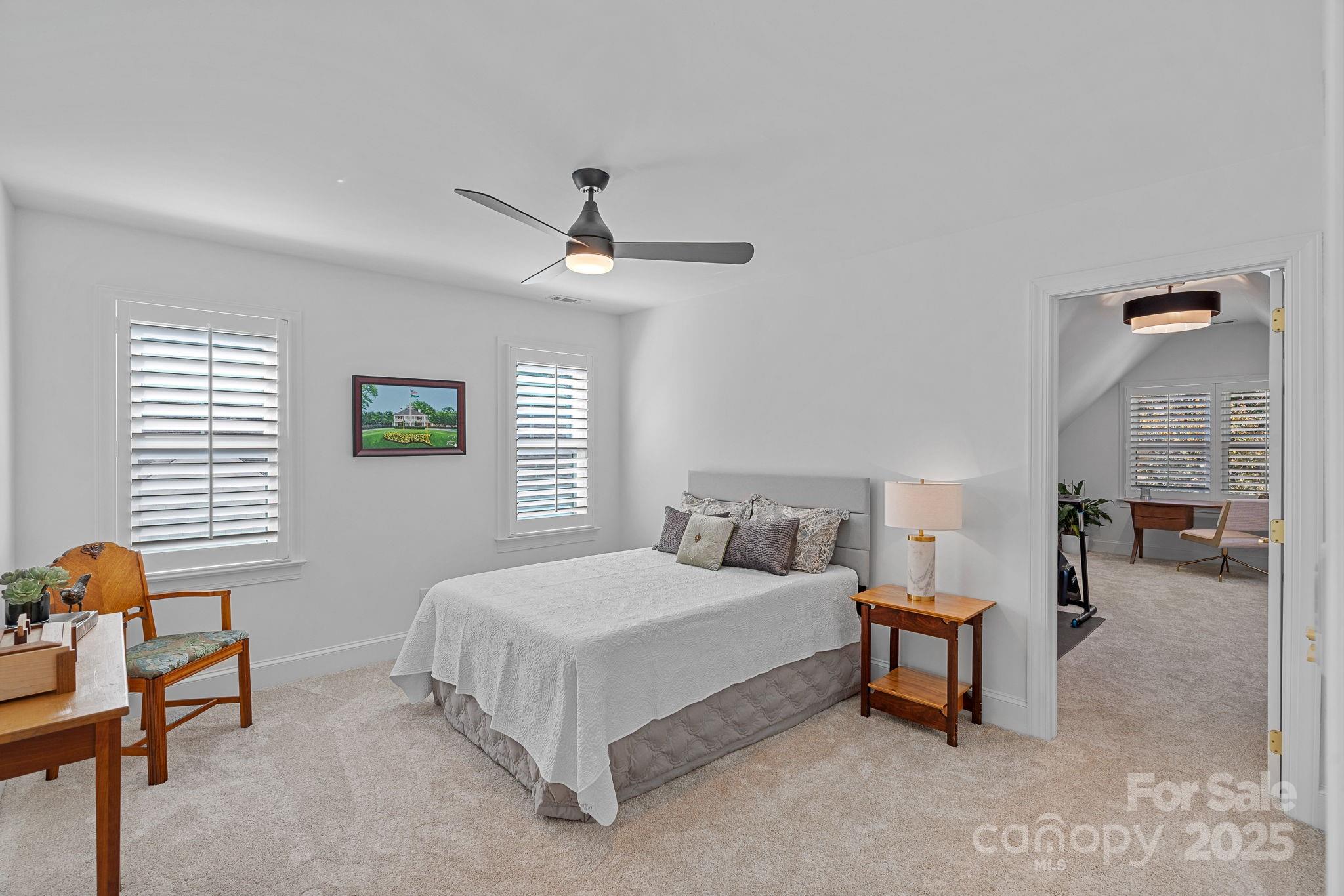 18613 John Connor Road Cornelius, NC 28031 - Photo 35 of 48 a spacious bedroom with a bed and a table