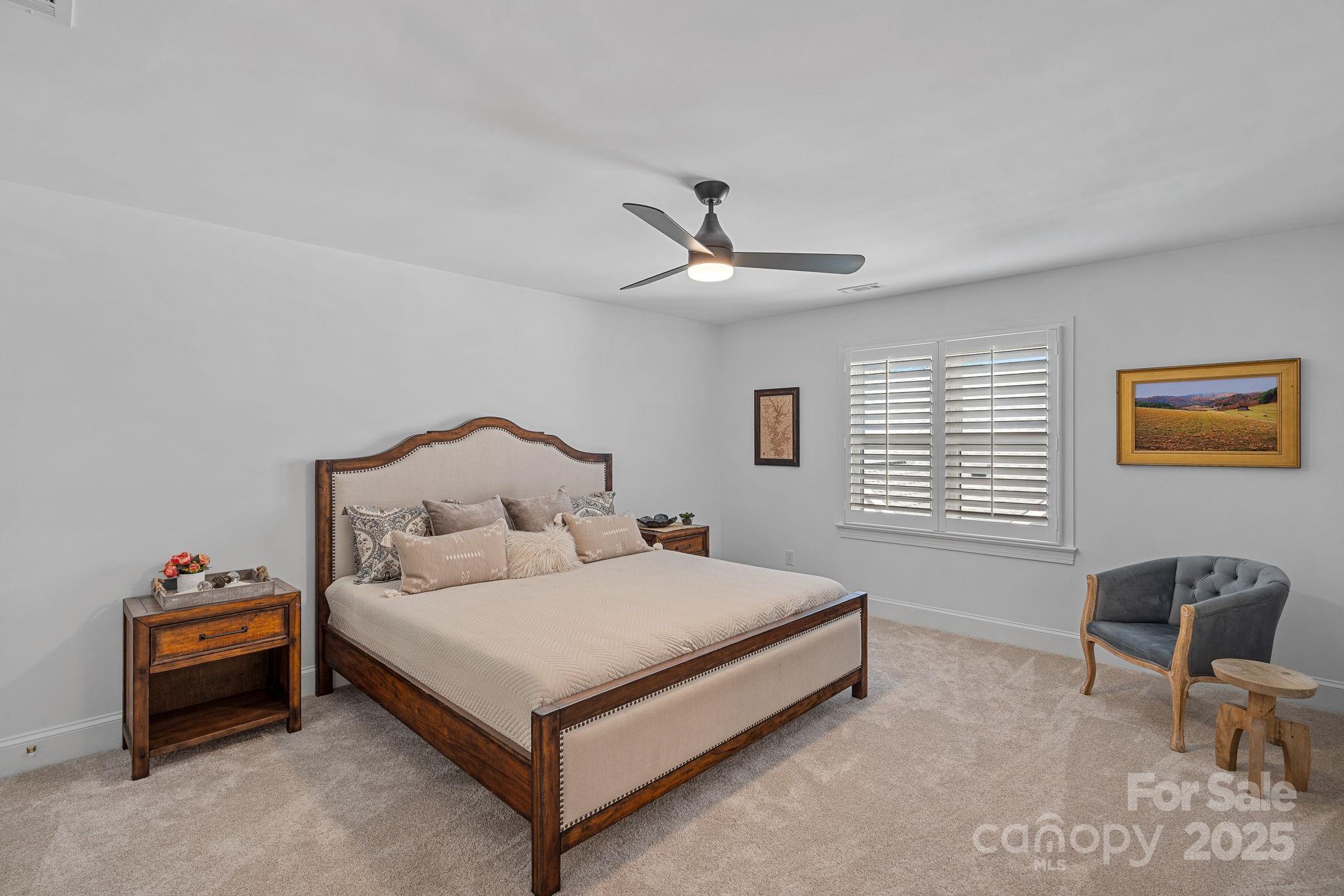 18613 John Connor Road Cornelius, NC 28031 - Photo 39 of 48 a bedroom with a bed and a chair