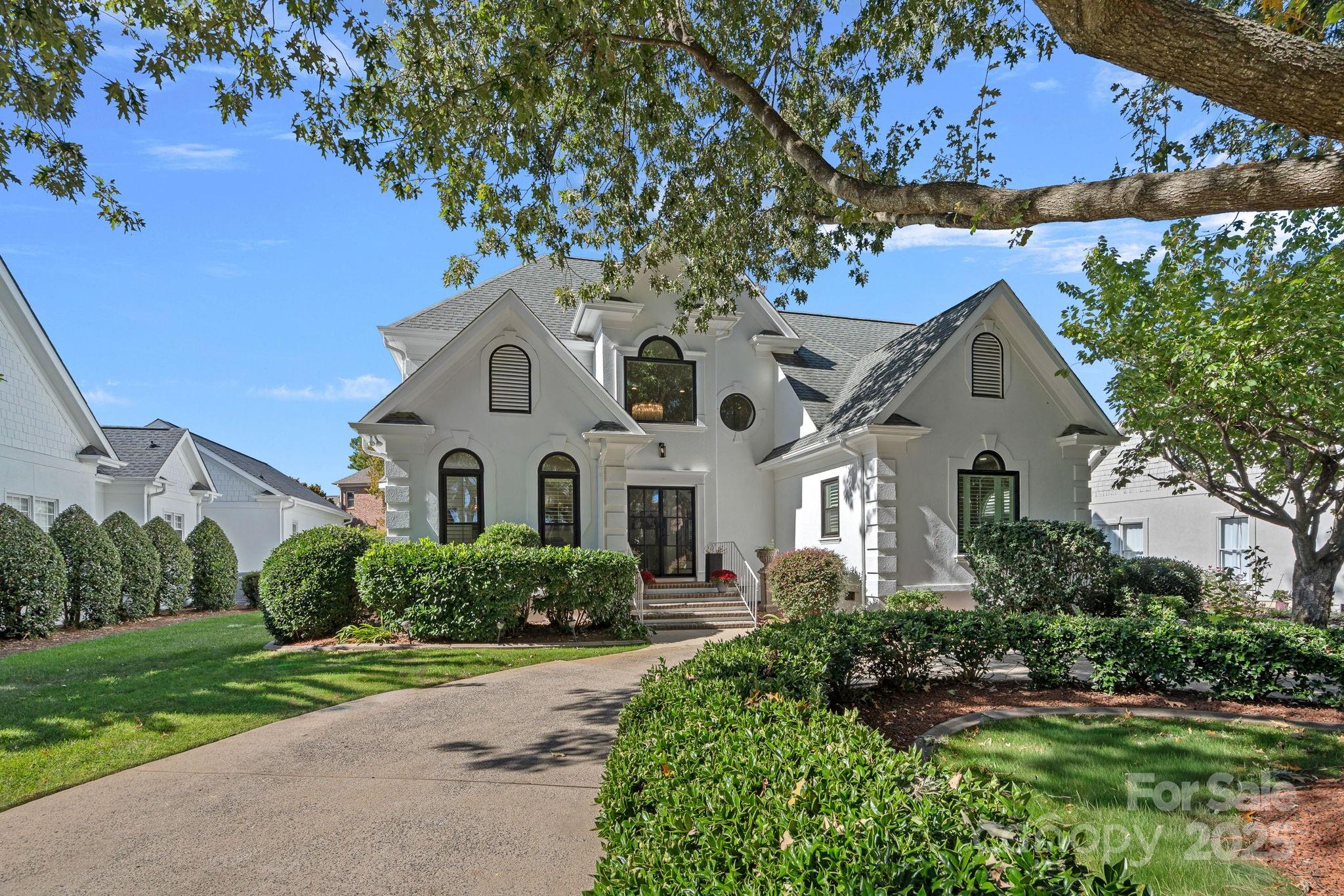 18613 John Connor Road Cornelius, NC 28031 - Photo 41 of 48 a front view of a house with a garden