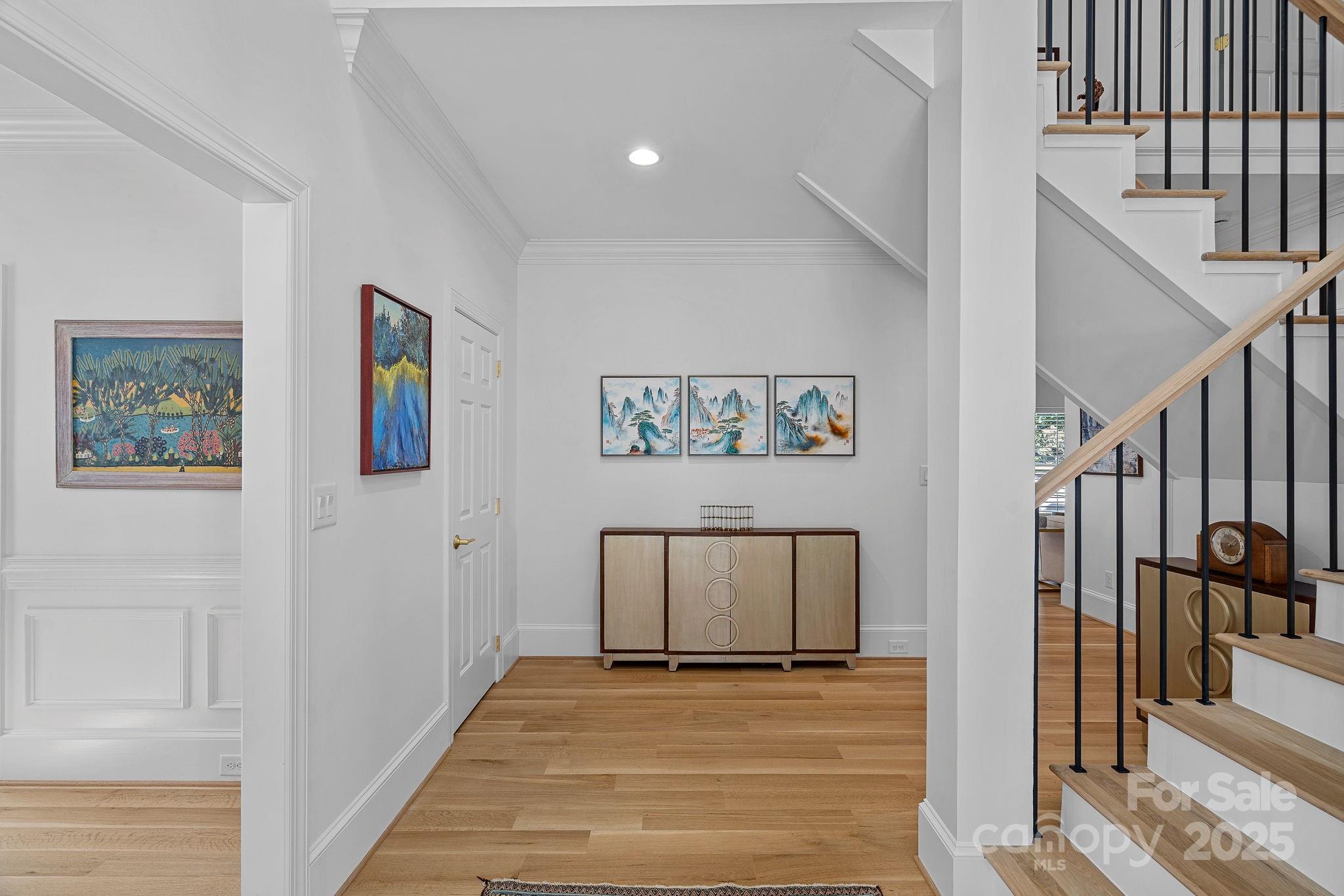 18613 John Connor Road Cornelius, NC 28031 - Photo 5 of 48 a view of a hallway with wooden floor and dining room