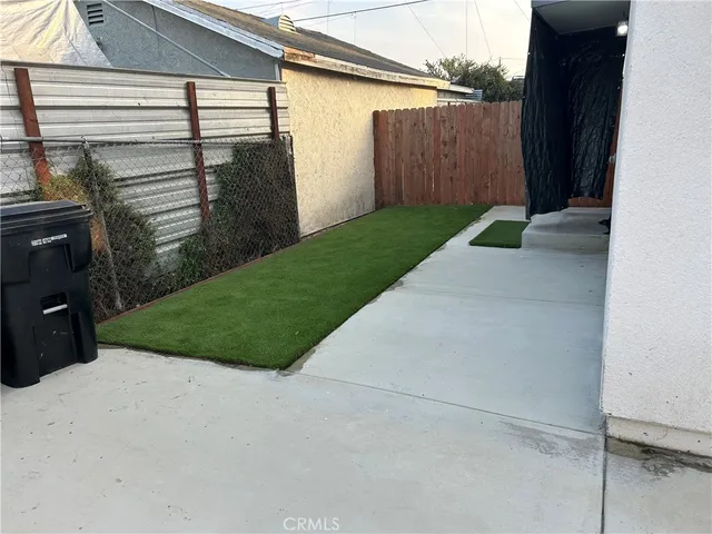 a view of a backyard with potted plants