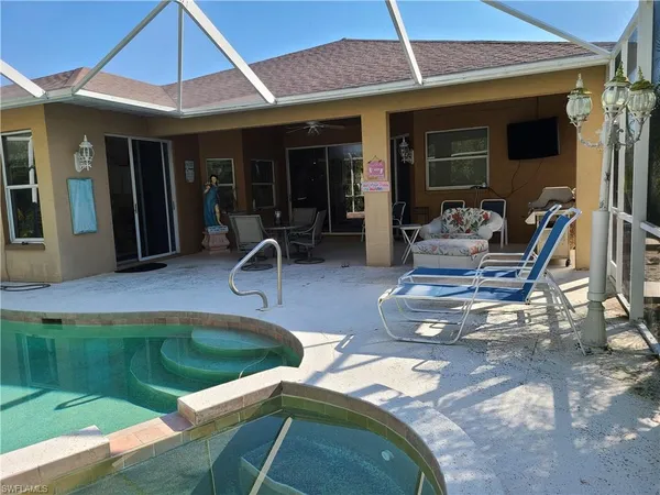a view of a house with swimming pool and furniture