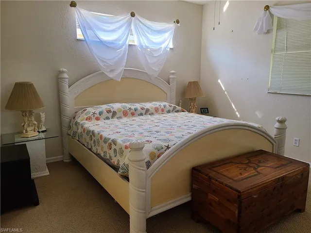 a bedroom with a bed and dresser