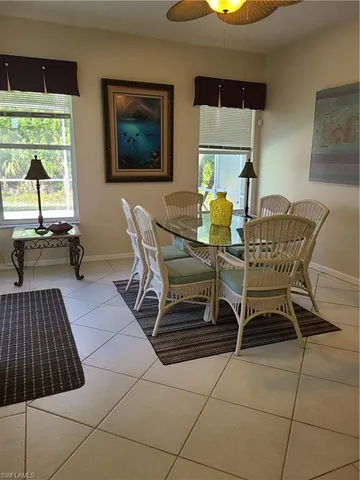 a dining room with furniture and a window