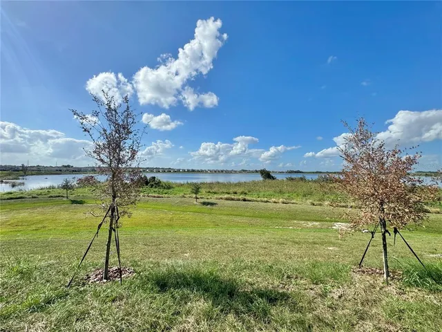 a view of kitchen and a hallway with wooden floor