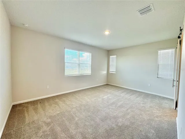 an empty room with closet and a window