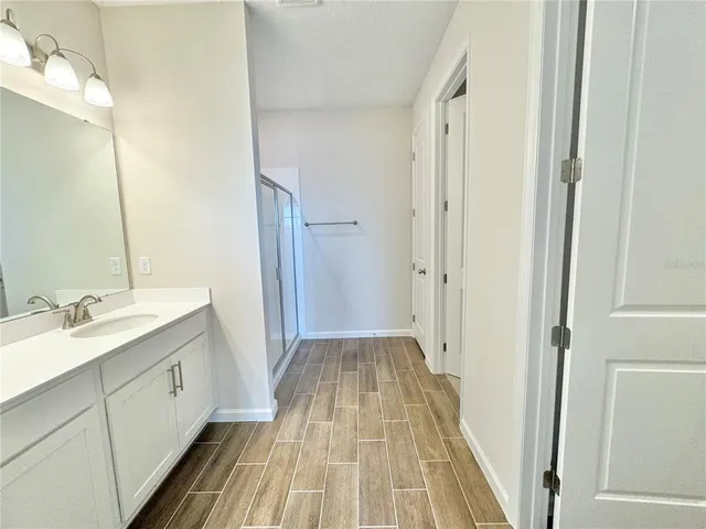 a bathroom with a double vanity sink and mirror