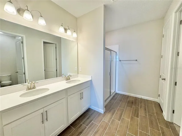 a view of a hallway with a wooden door