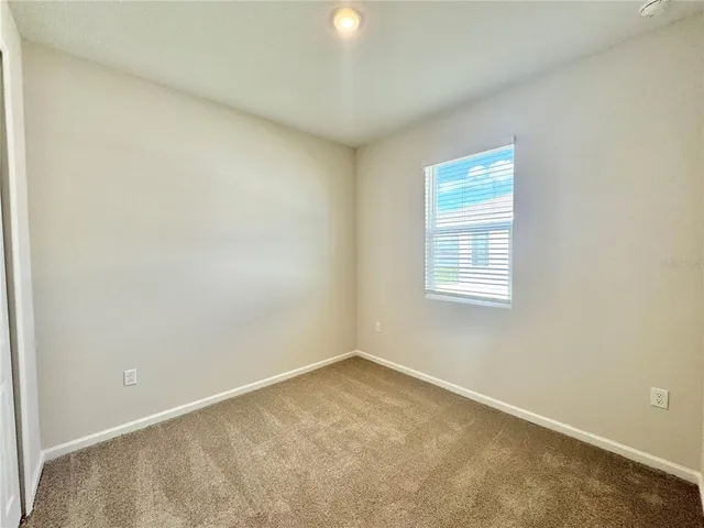 an empty room with closet area