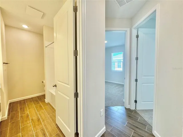 a spacious bathroom with a tub sink and mirror