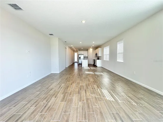 a view of an empty room and glass door