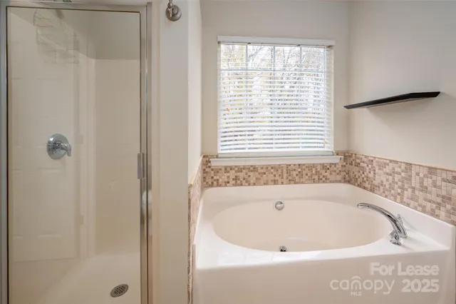 a view of swimming pool with large trees and plants