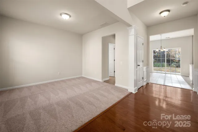 a kitchen with stainless steel appliances granite countertop a refrigerator a sink dishwasher a stove and white cabinets with wooden floor