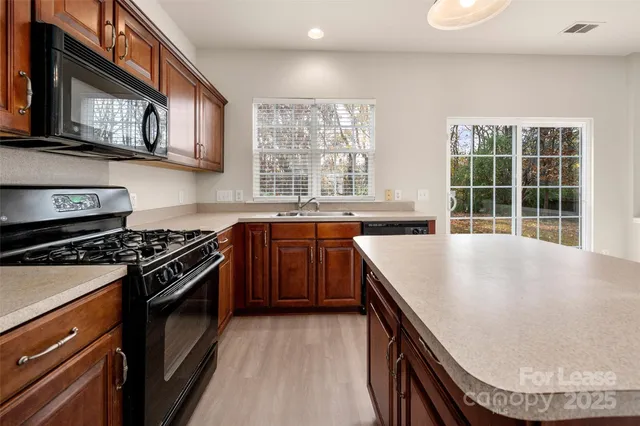 a view of empty room with fan and fireplace
