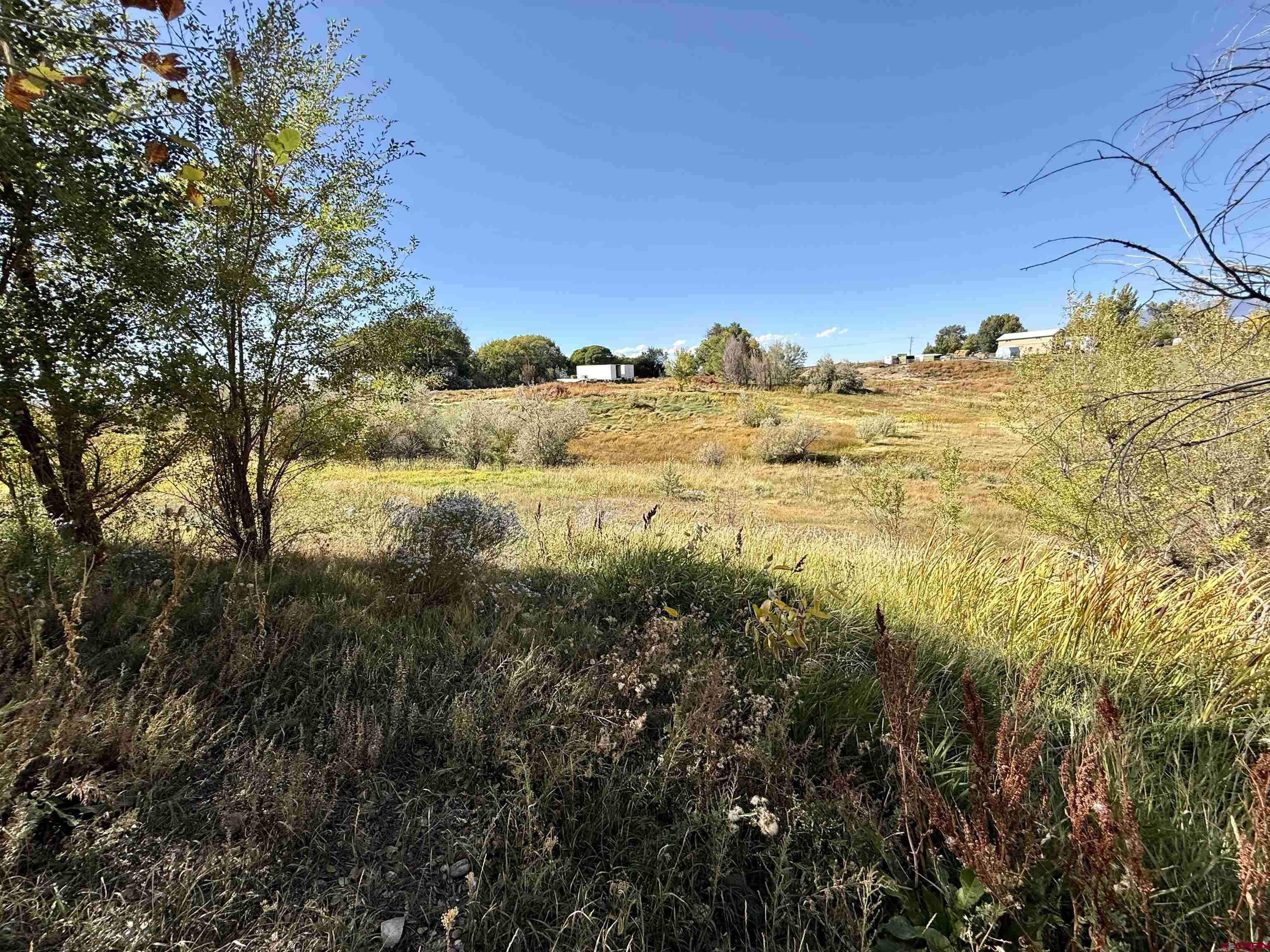 Lot 3 5500th Road Olathe, CO 81425 - Photo 10 of 22 a view of a large building with a mountain in the background