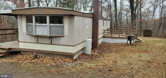a view of a house with a yard and wooden fence