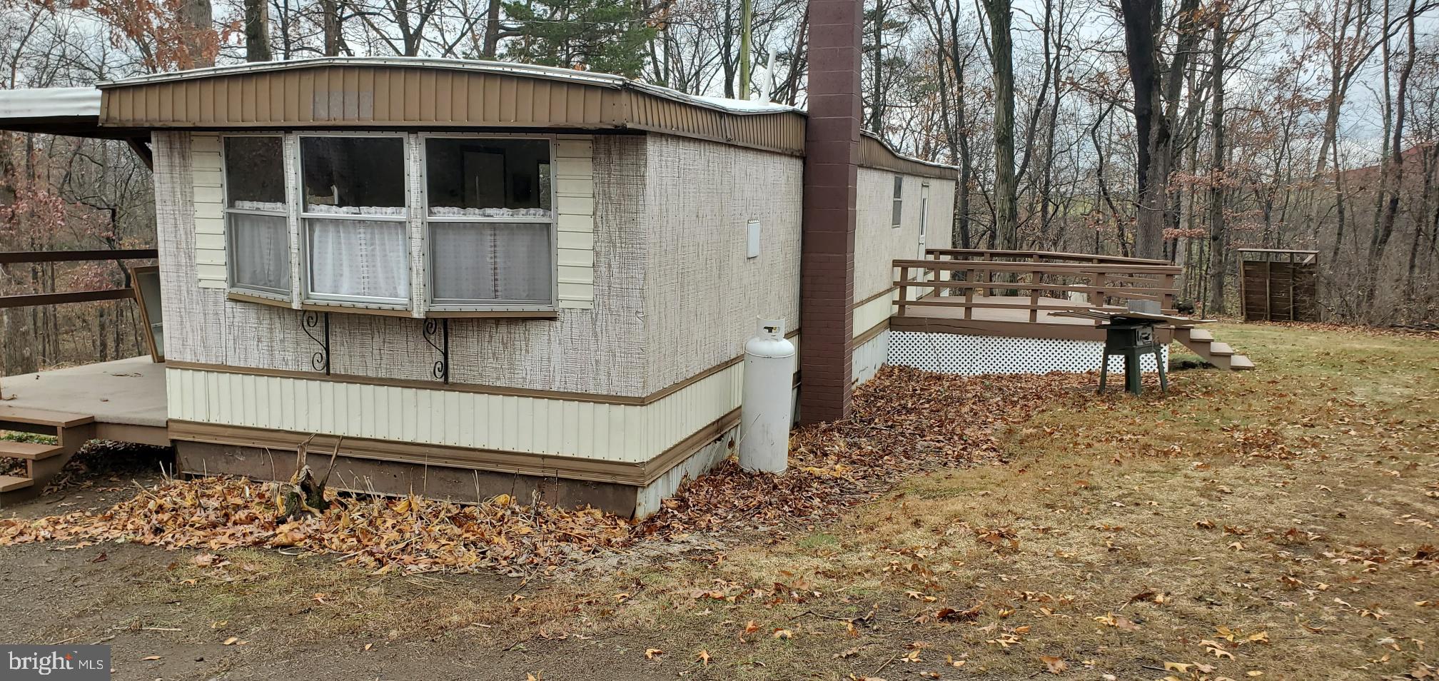 a view of a house with a yard and wooden fence