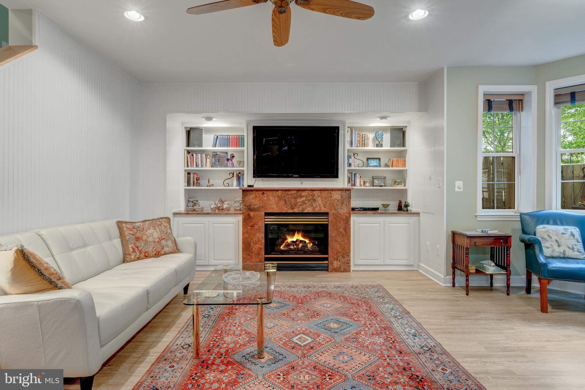 1925 Logan Manor Drive Reston, VA 20190 - Photo 31 of 61 a living room with furniture a flat screen tv and a fireplace