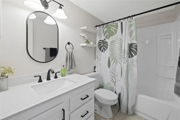 a bathroom with a toilet a sink and a mirror