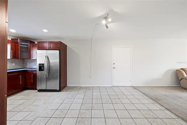 a kitchen with granite countertop a refrigerator and a stove