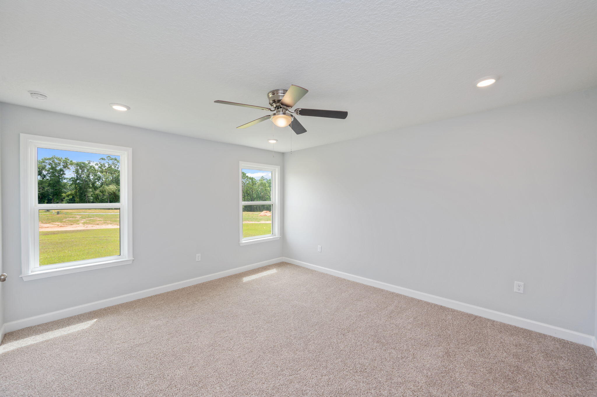 3863 Poverty Creek Road Crestview, FL 32539 - Photo 16 of 31 an empty room with windows and ceiling fan