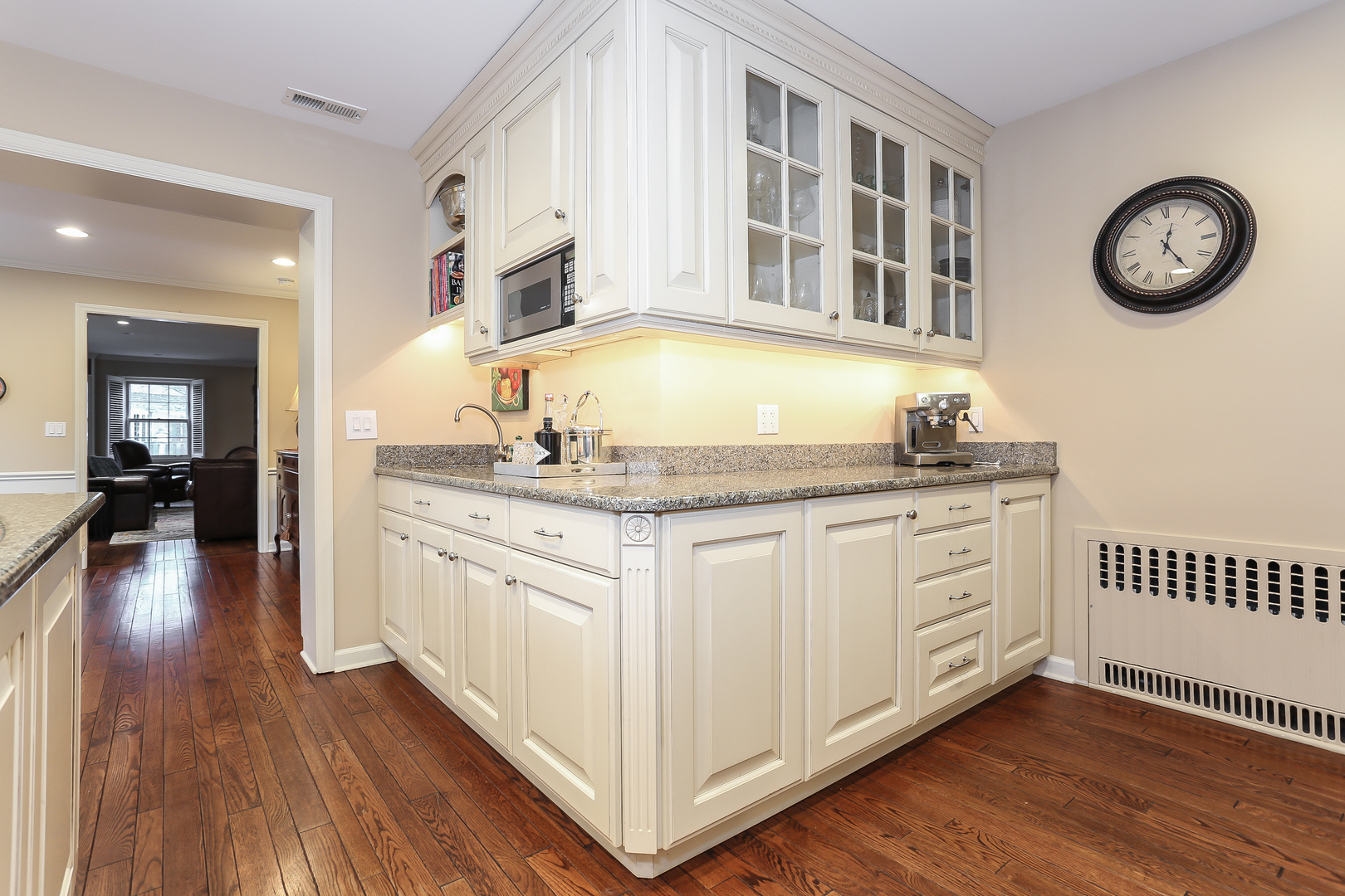 1350 Inverlieth Road Lake Forest, IL 60045 - Photo 11 of 43 a hall with kitchen island granite countertop white cabinets and wooden floor