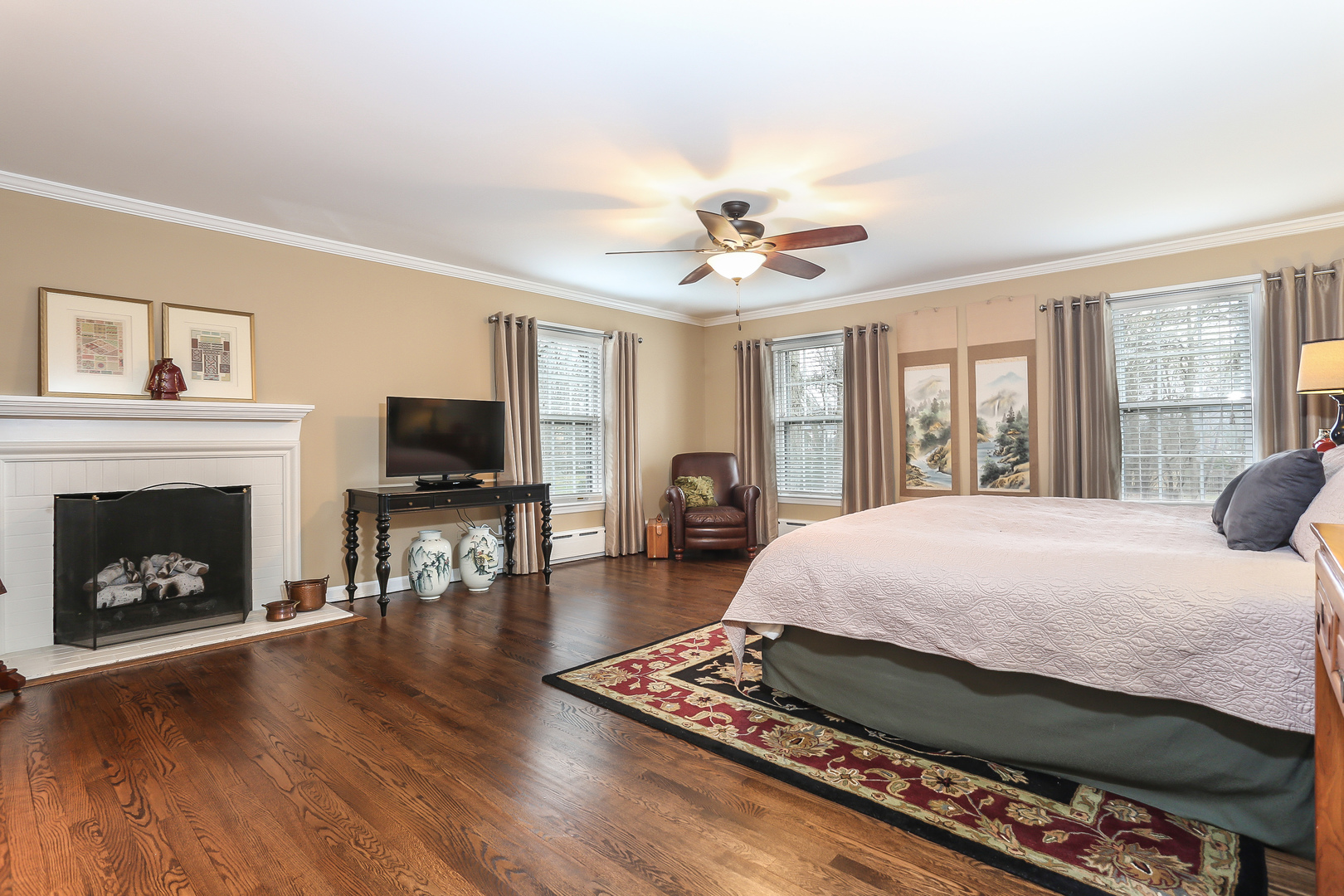 1350 Inverlieth Road Lake Forest, IL 60045 - Photo 19 of 43 a spacious bedroom with a bed a fireplace and a flat screen tv