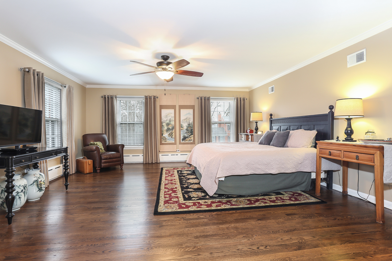 1350 Inverlieth Road Lake Forest, IL 60045 - Photo 20 of 43 a spacious bedroom with a bed a couch and a flat tv screen on the dresser