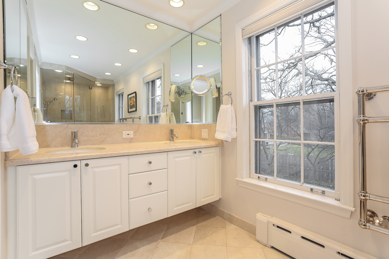 1350 Inverlieth Road Lake Forest, IL 60045 - Photo 22 of 43 a spacious bathroom with a double vanity sink a large mirror and a shower