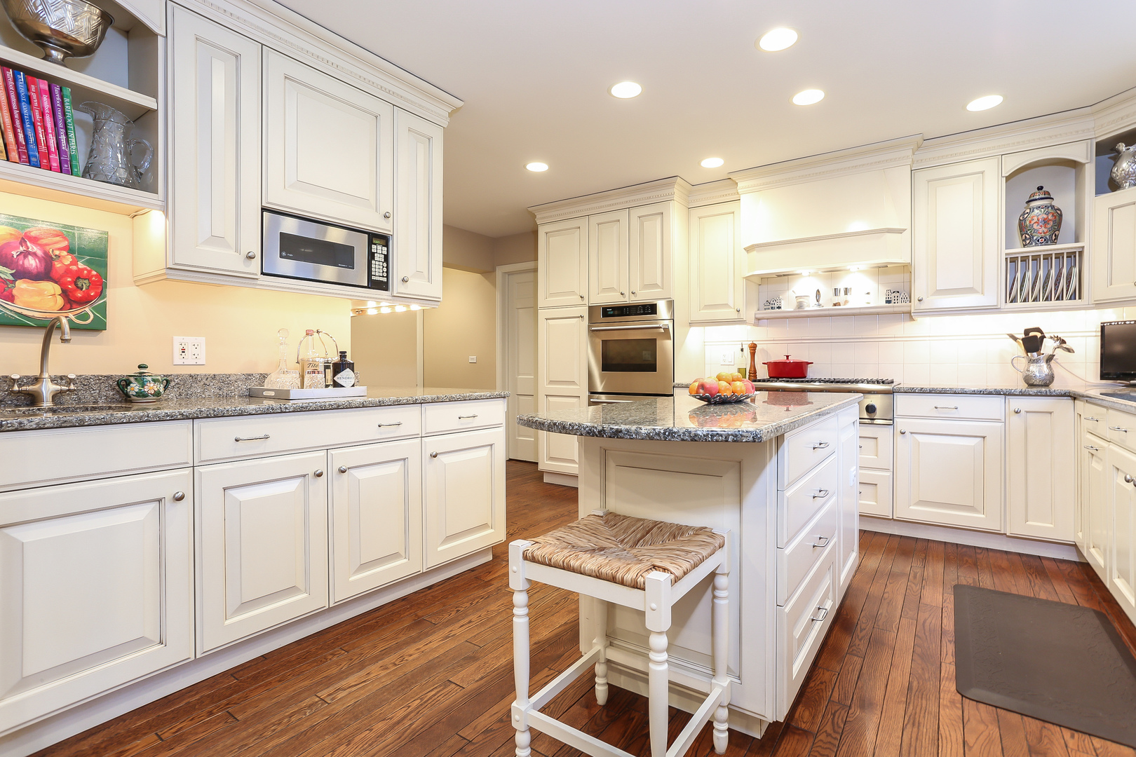 1350 Inverlieth Road Lake Forest, IL 60045 - Photo 10 of 43 a kitchen with stainless steel appliances granite countertop a sink dishwasher a stove and white cabinets with wooden floor