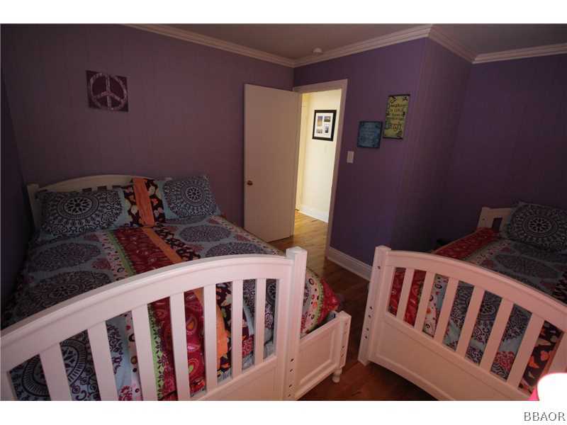 535 Highland Road Big Bear Lake, CA 92315 - Photo 13 of 15 a bedroom with a bed and wooden floor