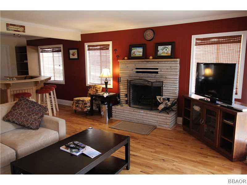 535 Highland Road Big Bear Lake, CA 92315 - Photo 2 of 15 a living room with furniture a flat screen tv and a fireplace