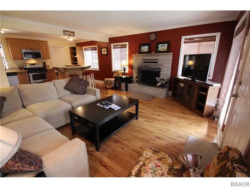 535 Highland Road Big Bear Lake, CA 92315 - Photo 4 of 15 a living room with furniture a flat screen tv and a fireplace