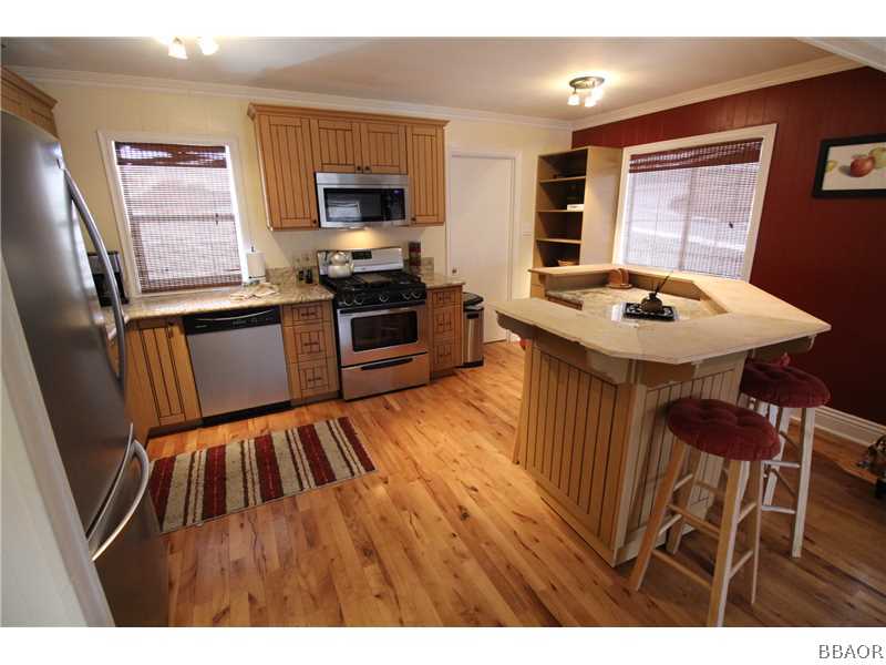 535 Highland Road Big Bear Lake, CA 92315 - Photo 6 of 15 a kitchen with a sink appliances and cabinets