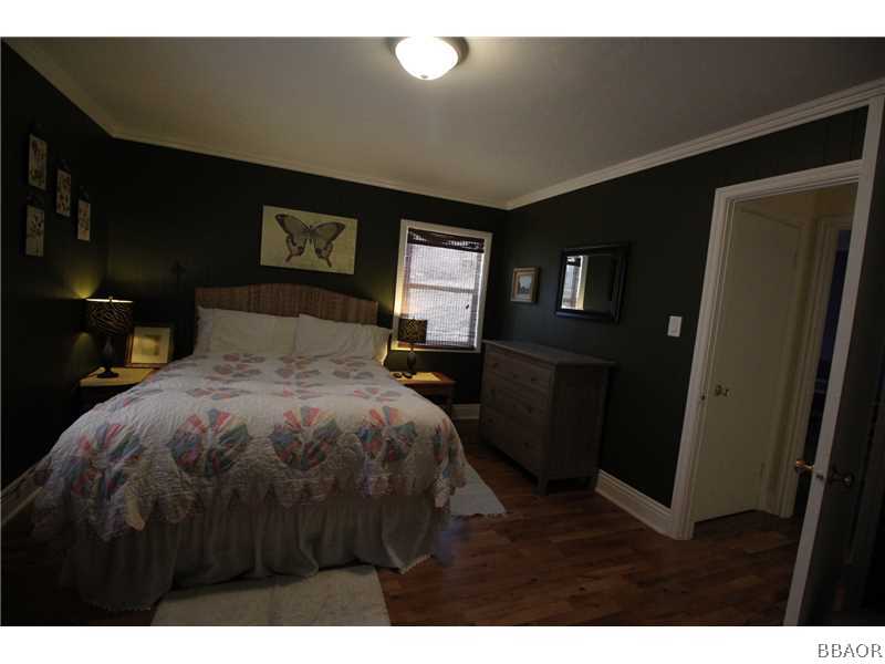 535 Highland Road Big Bear Lake, CA 92315 - Photo 7 of 15 a bedroom with a bed and a night stand