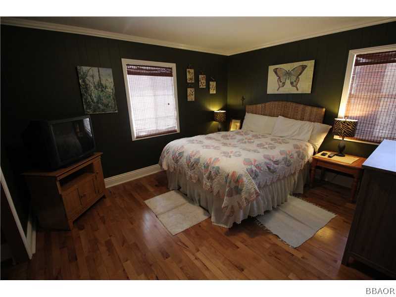 535 Highland Road Big Bear Lake, CA 92315 - Photo 8 of 15 a bedroom with a bed and wooden floor
