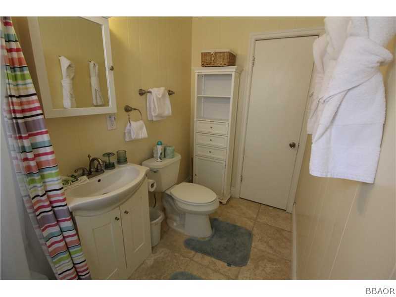 535 Highland Road Big Bear Lake, CA 92315 - Photo 9 of 15 a bathroom with a sink mirror toilet and shower