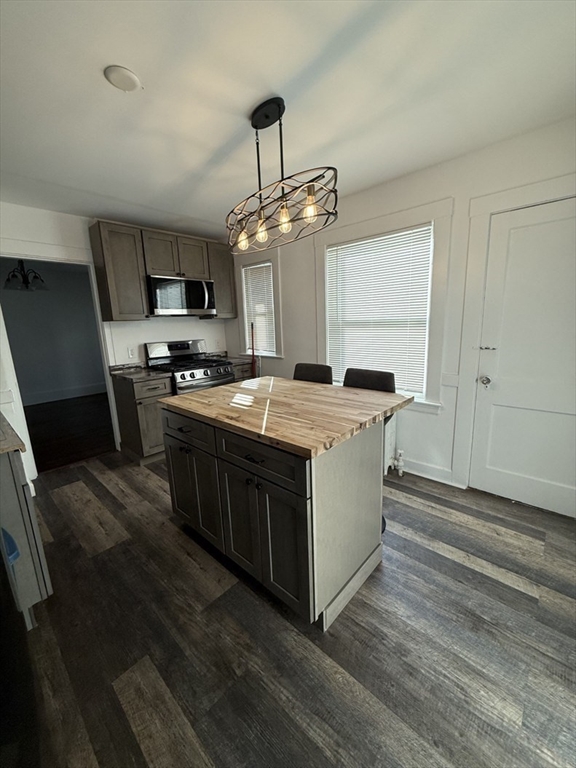 a kitchen with a stove a sink and a refrigerator