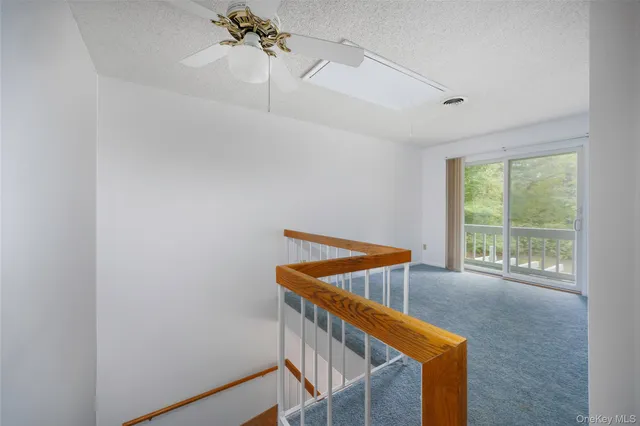 a spacious bedroom with a bed and a chandelier