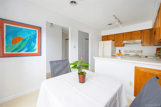 a kitchen with a sink a refrigerator and cabinets