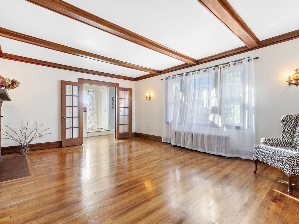 149 Trapelo Road Waltham, MA 02452 - Photo 11 of 36 a view of an empty room with wooden floor and a window