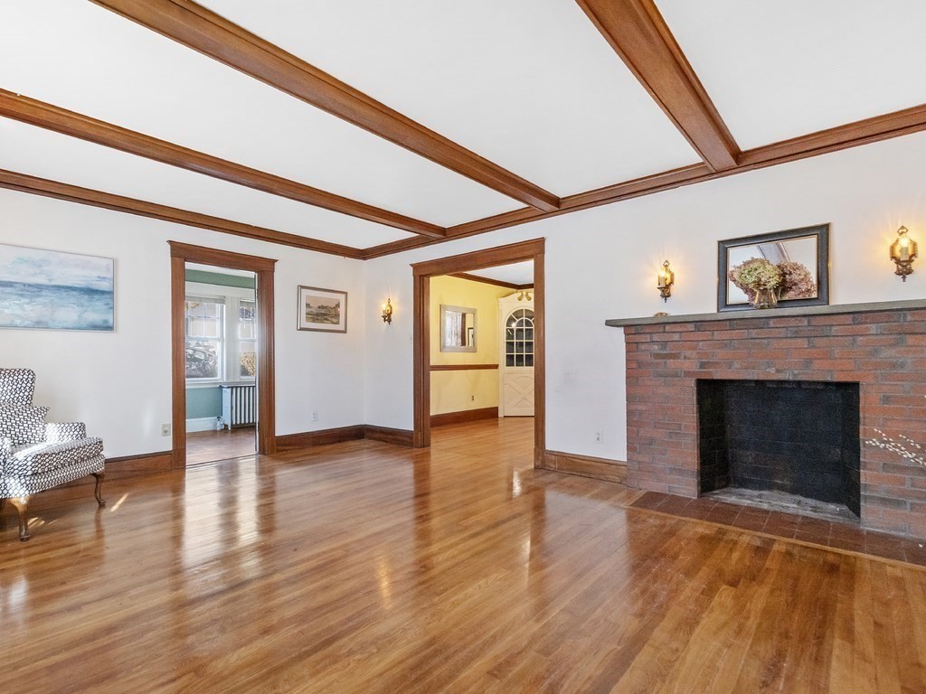 149 Trapelo Road Waltham, MA 02452 - Photo 12 of 36 a view of an empty room with wooden floor fireplace and a window